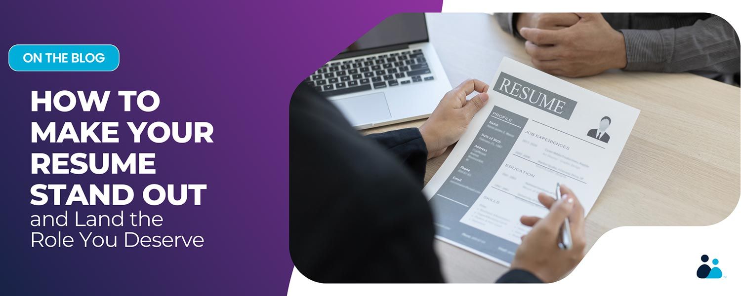 A person holding a printed resume while discussing it with another person across a table.